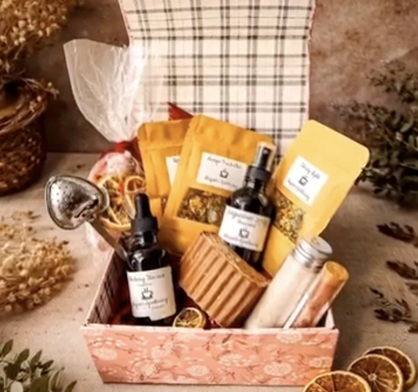 A gift box packed with tea pouches, soap, a tincture and bath salts